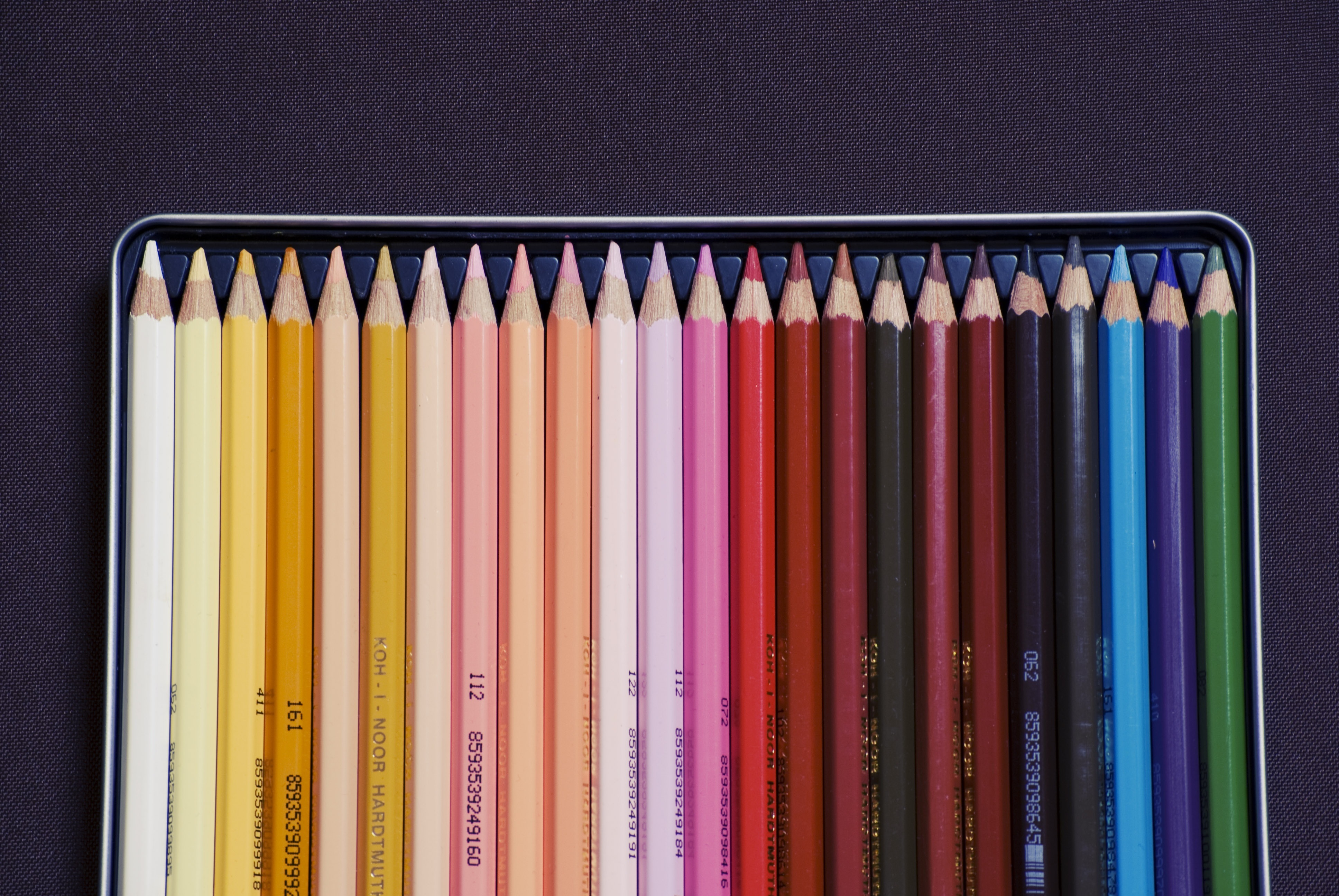 colored pencils in a tin