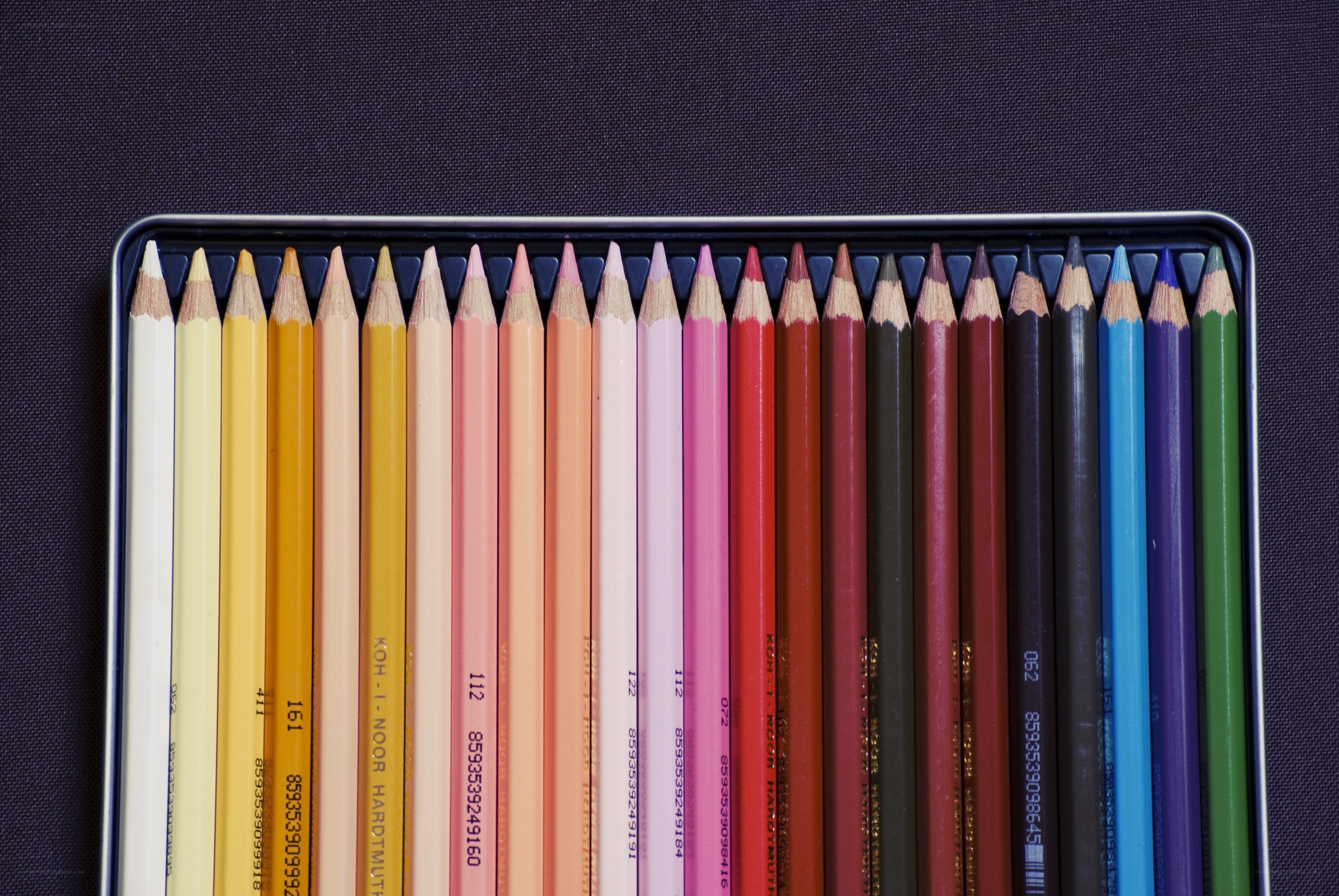 colored pencils in a tin