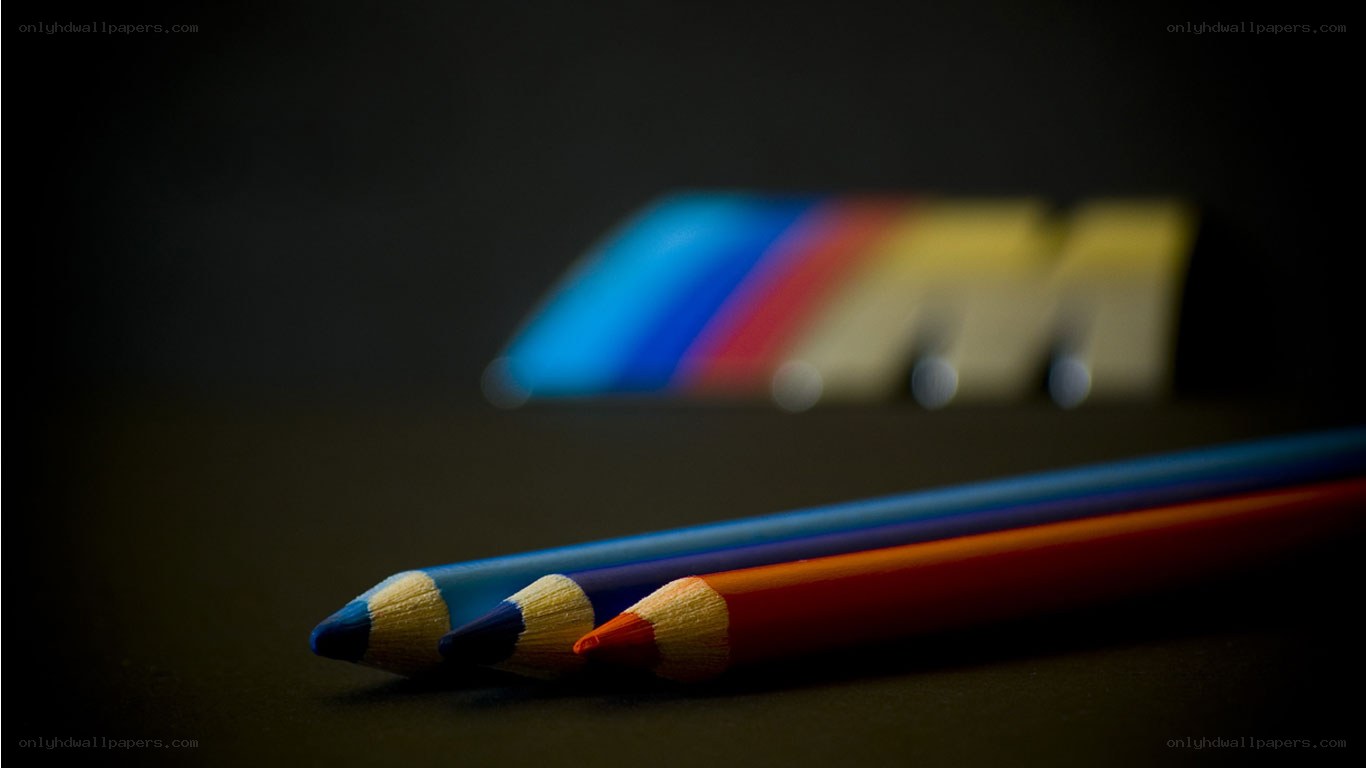 Colored pencils with blurred logo