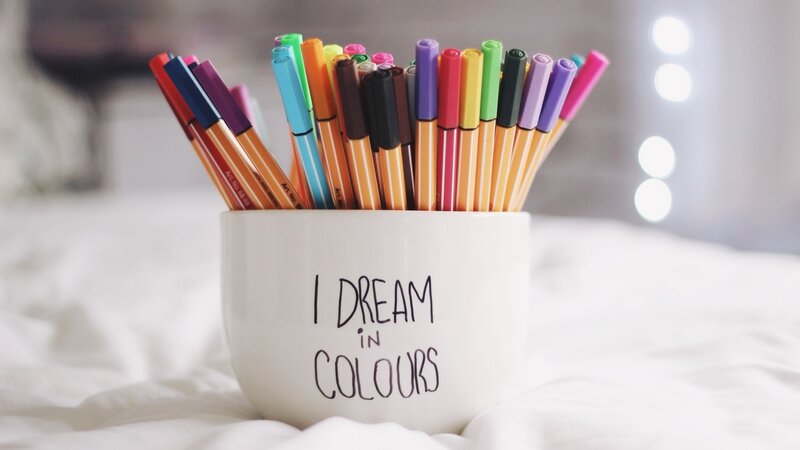 Colored pens in a cup