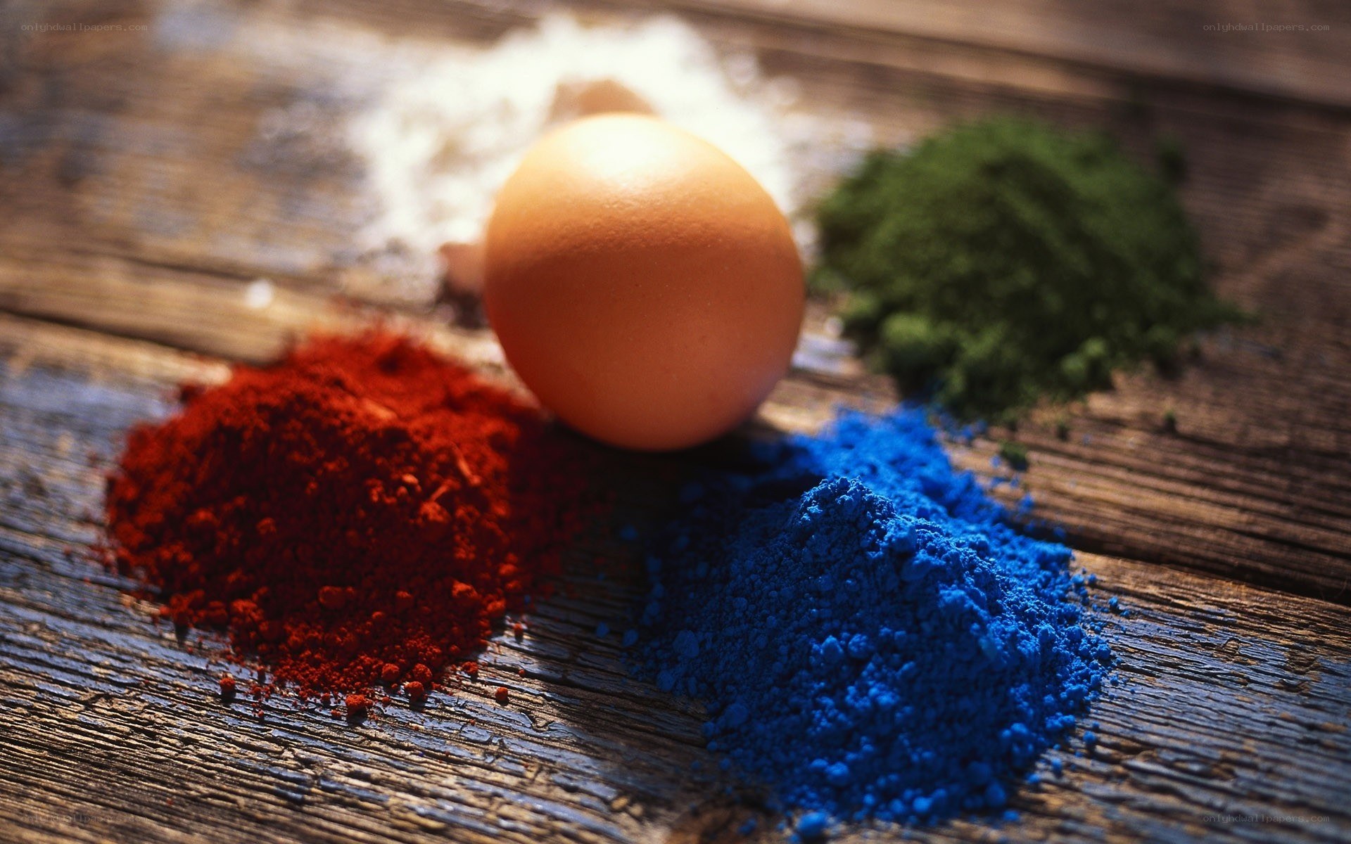 colored powders and an egg