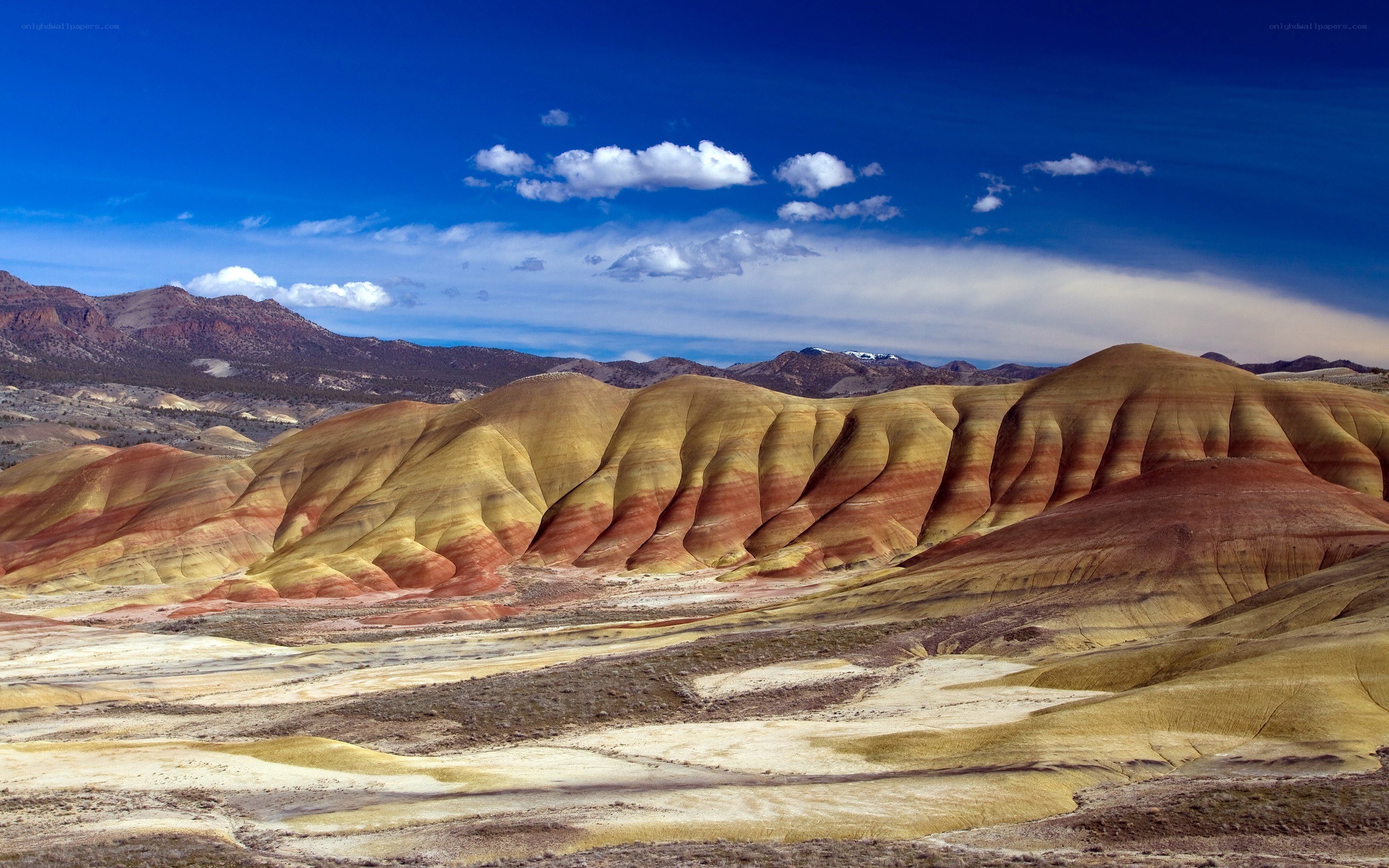 Colorful badlands under blue sky