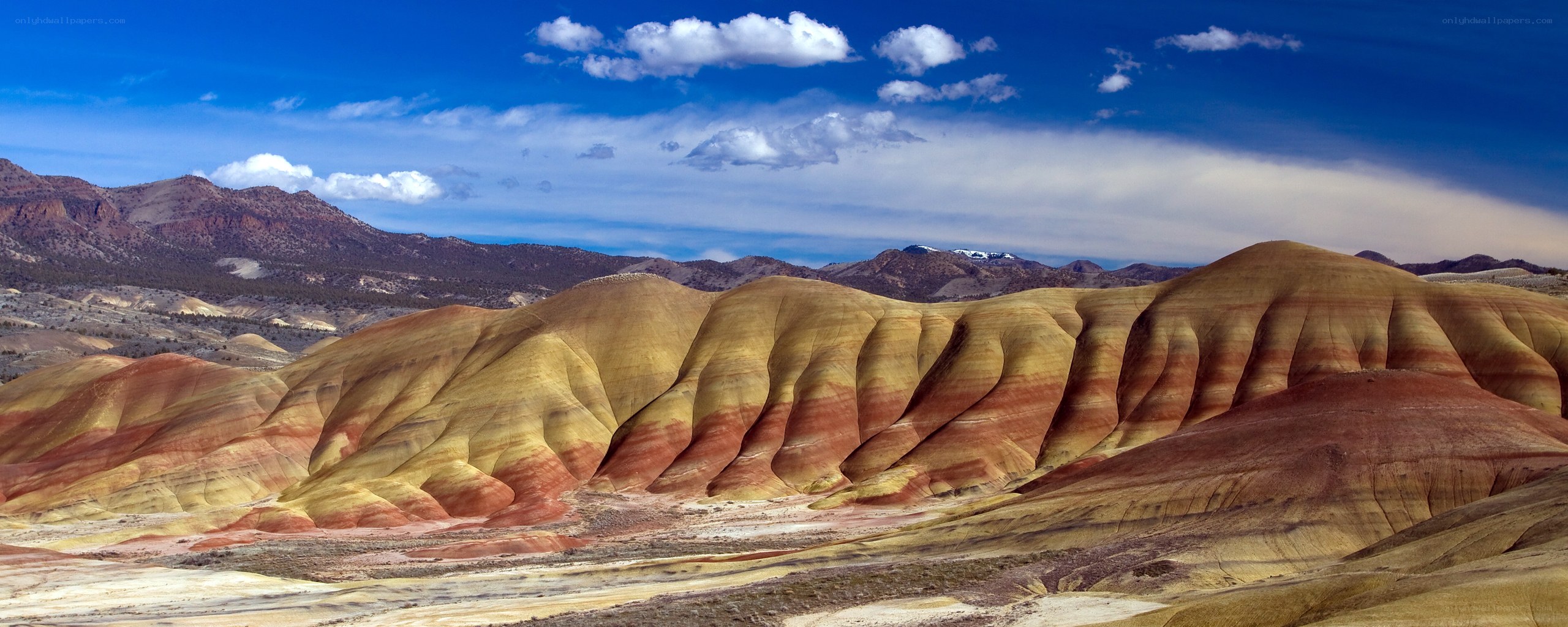 Colorful badlands under blue sky