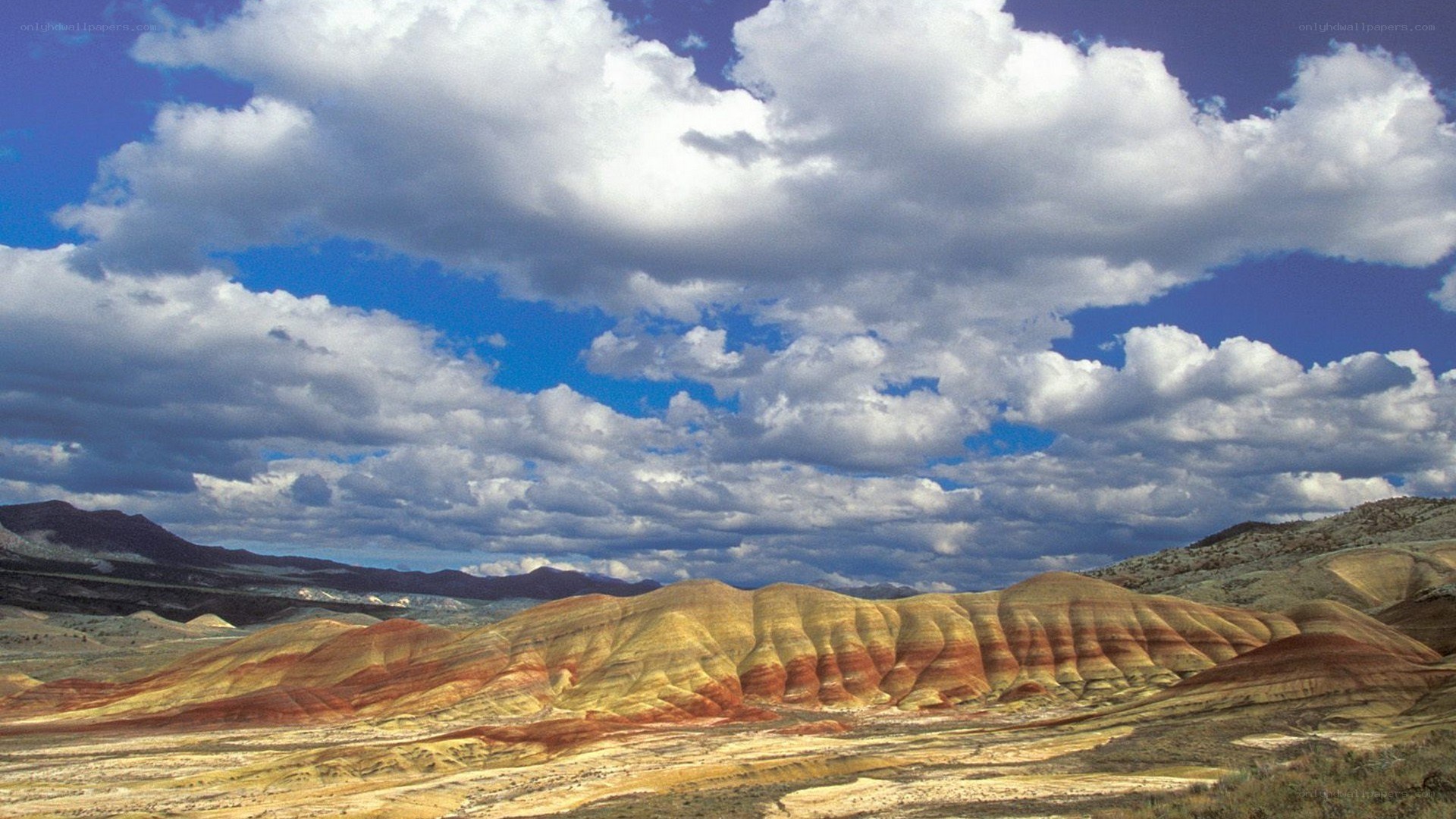 Colorful badlands under cloudy sky