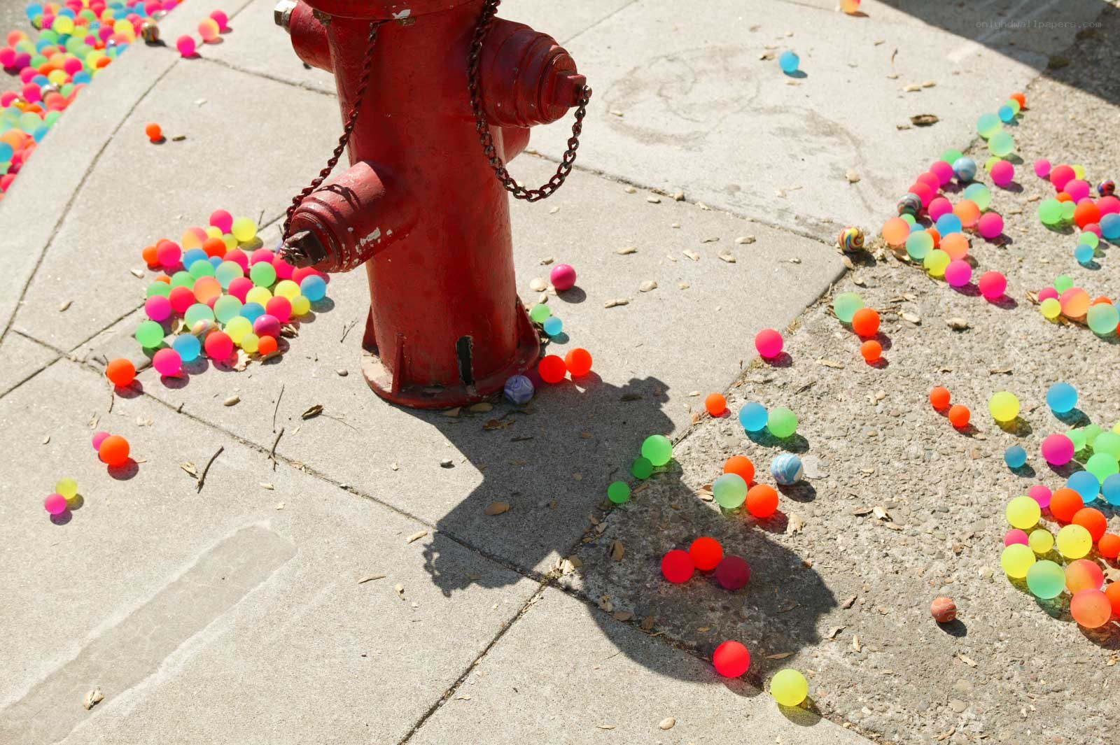 Colorful balls around a fire hydrant
