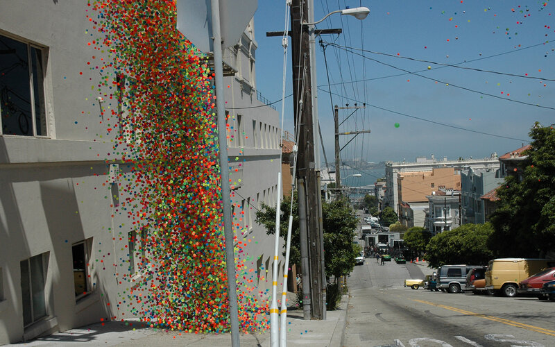 Colorful balls falling on a city street