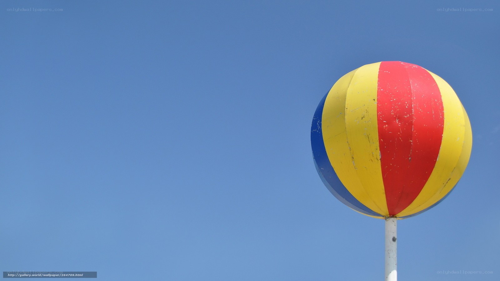 Colorful beach ball against blue sky