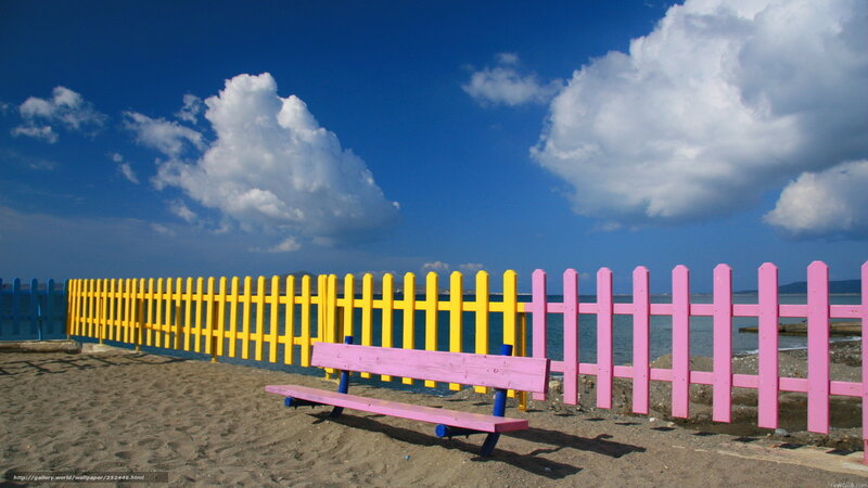 Colorful beach bench and fence