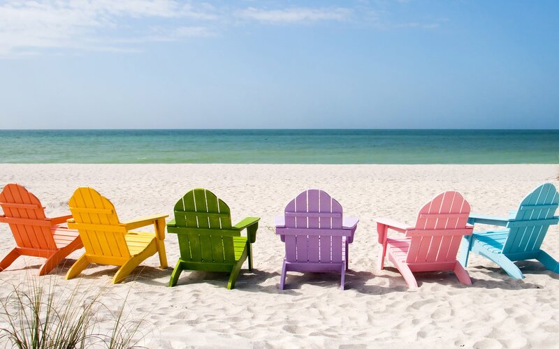 Colorful beach chairs on sand