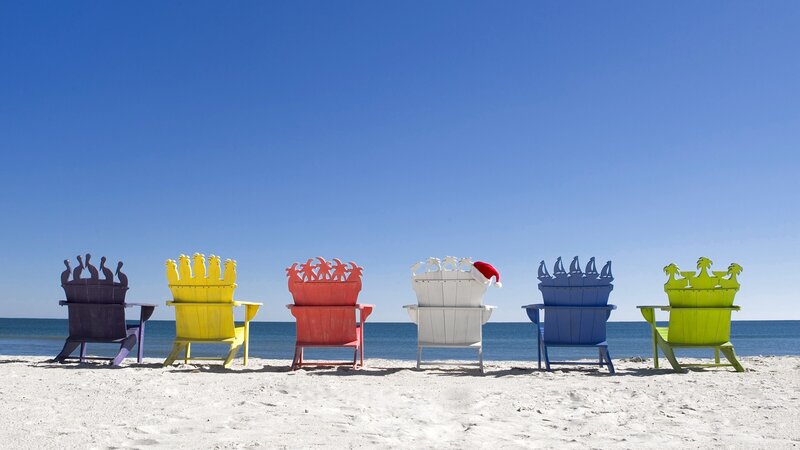 Colorful beach chairs on sand