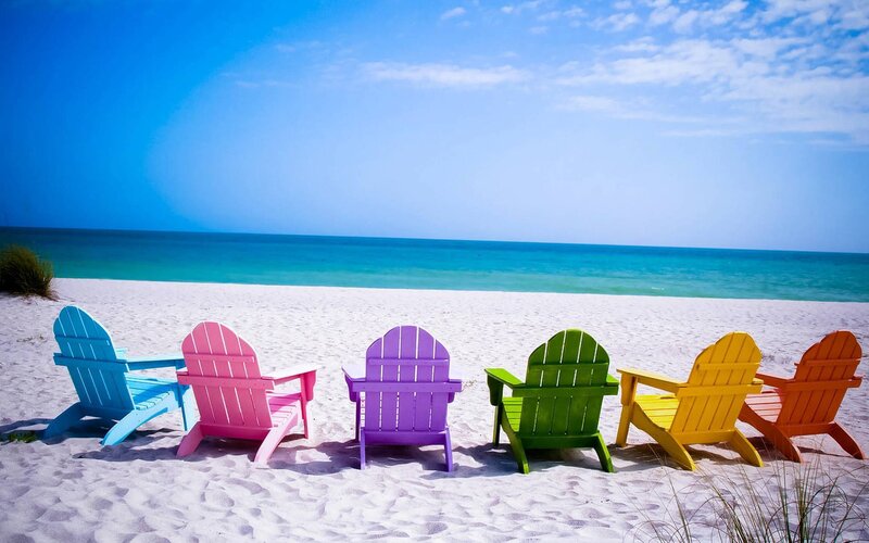 Colorful beach chairs on sand