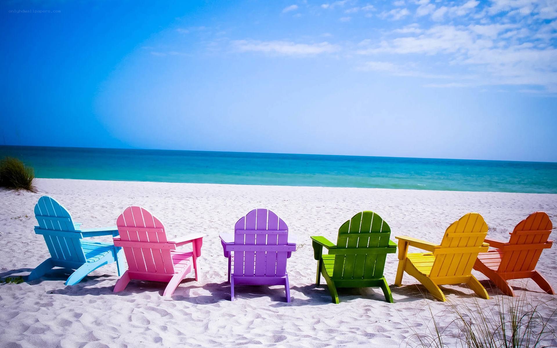 Colorful beach chairs on sand