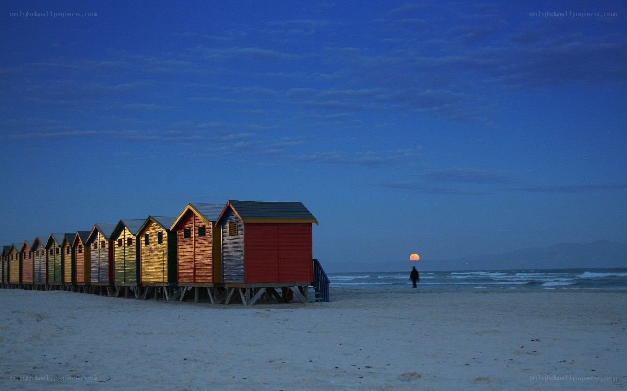 Colorful beach huts at dusk
