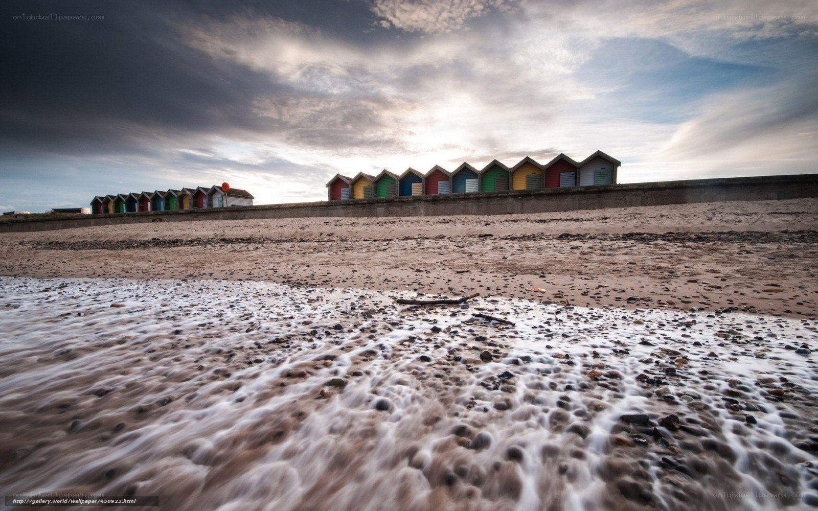 Colorful beach huts at sunset