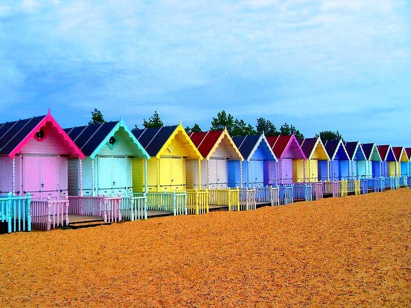 Colorful beach huts on a pebble shore
