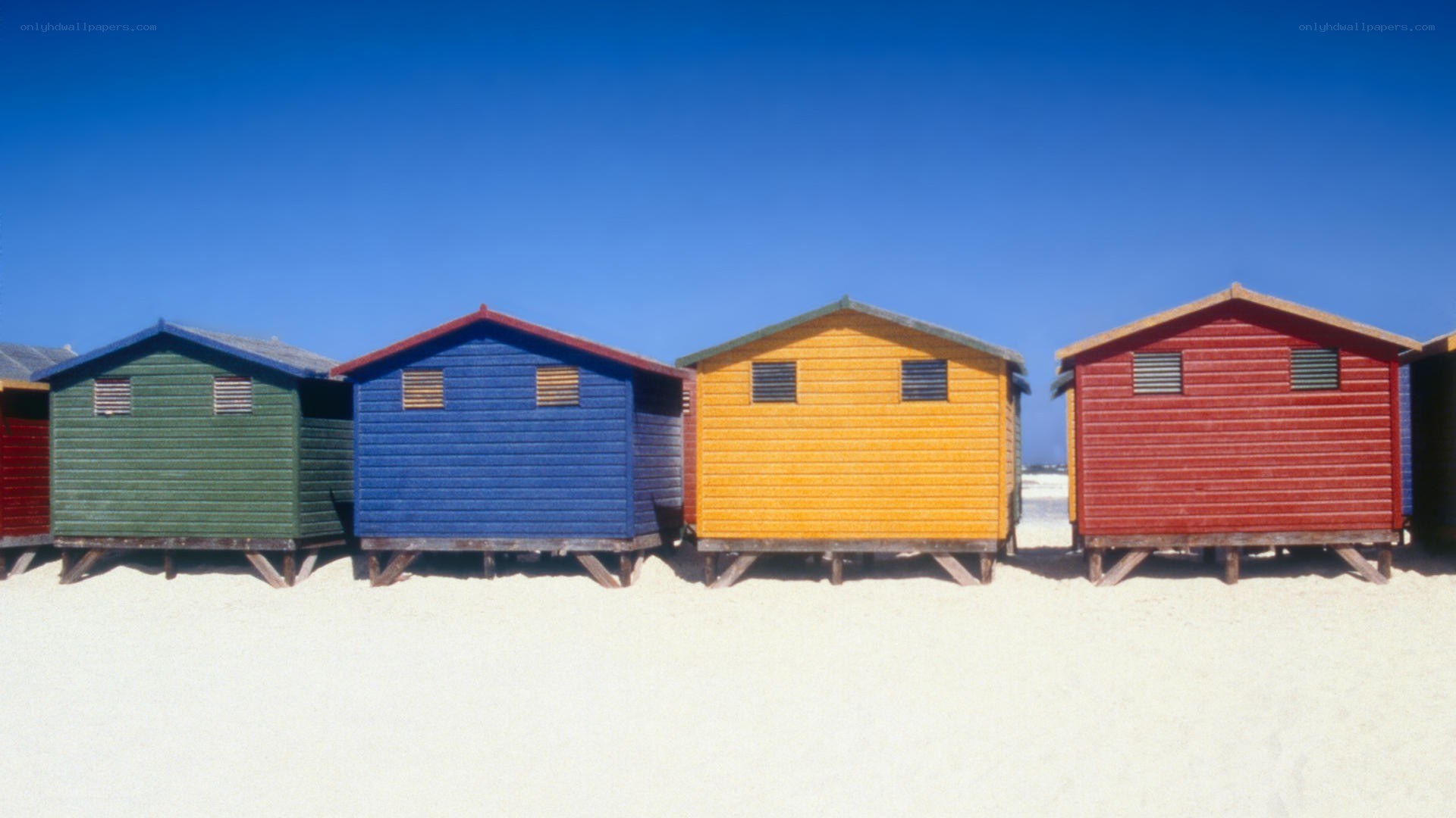 Colorful beach huts on sand