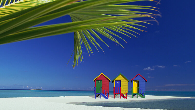 Colorful beach huts on tropical island
