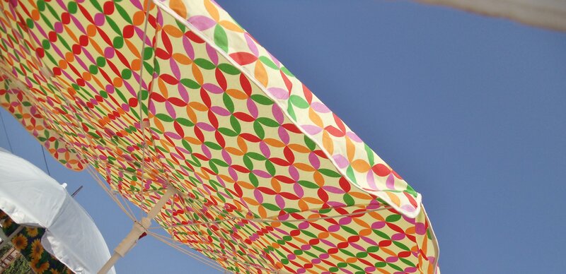 Colorful beach umbrella against blue sky