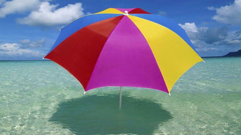 Colorful beach umbrella in ocean
