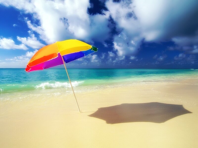 Colorful beach umbrella on sand