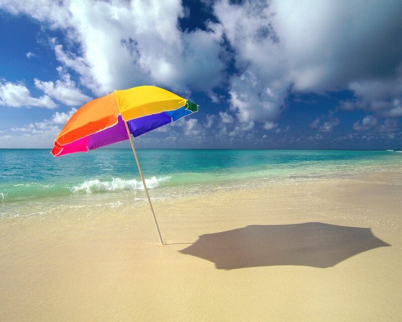 Colorful beach umbrella on sand