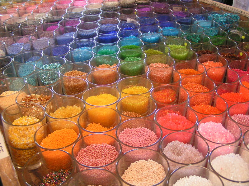 Colorful beads in glass jars