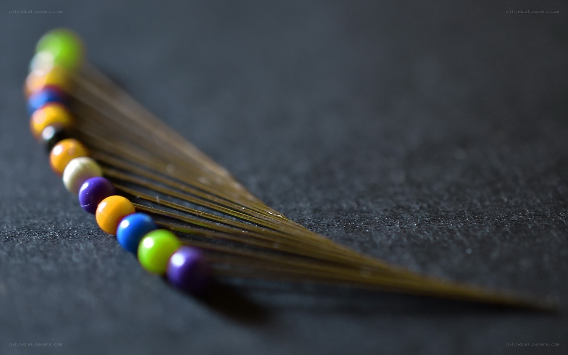 Colorful beads on a feather