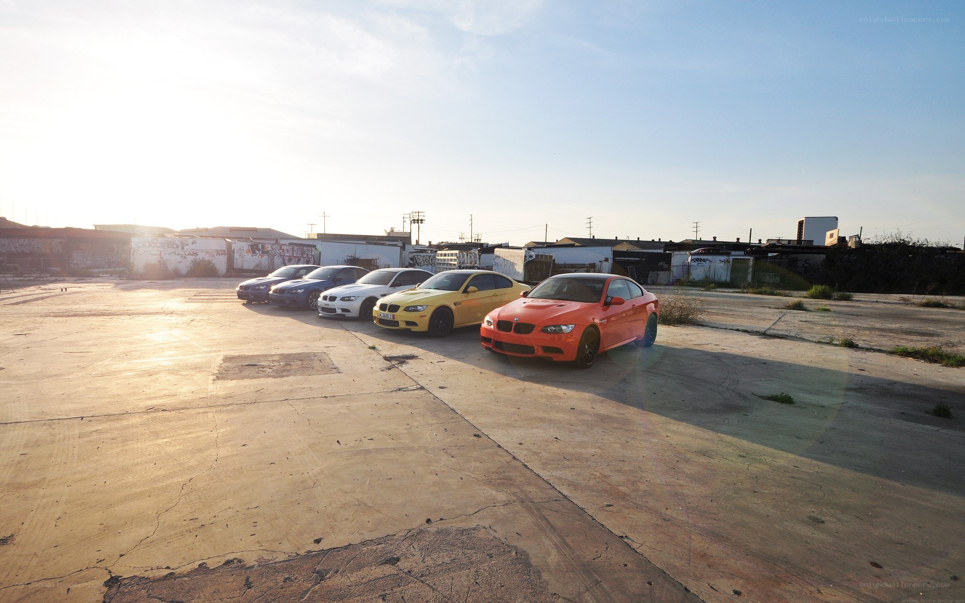 Colorful BMWs in an empty lot