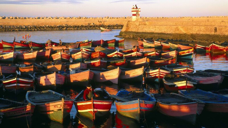 Colorful boats in a harbor at sunset