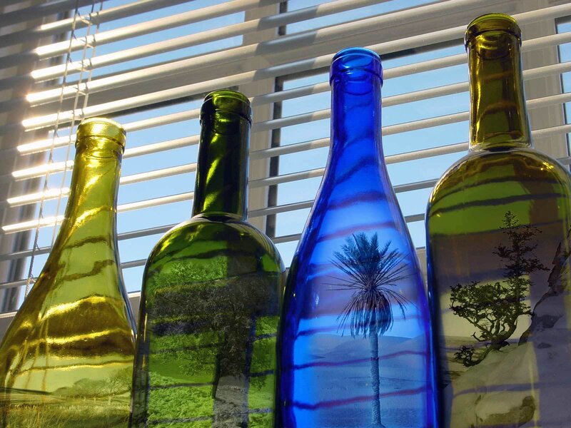 Colorful bottles with landscape reflections