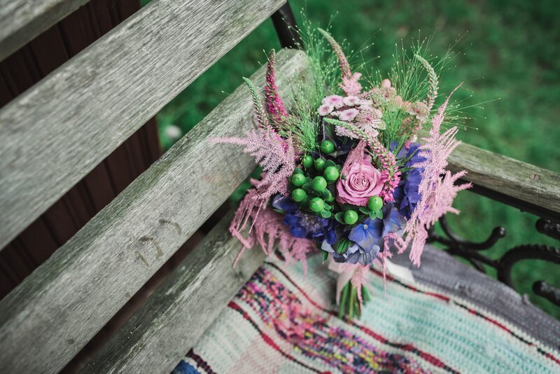 Colorful bouquet on wooden bench