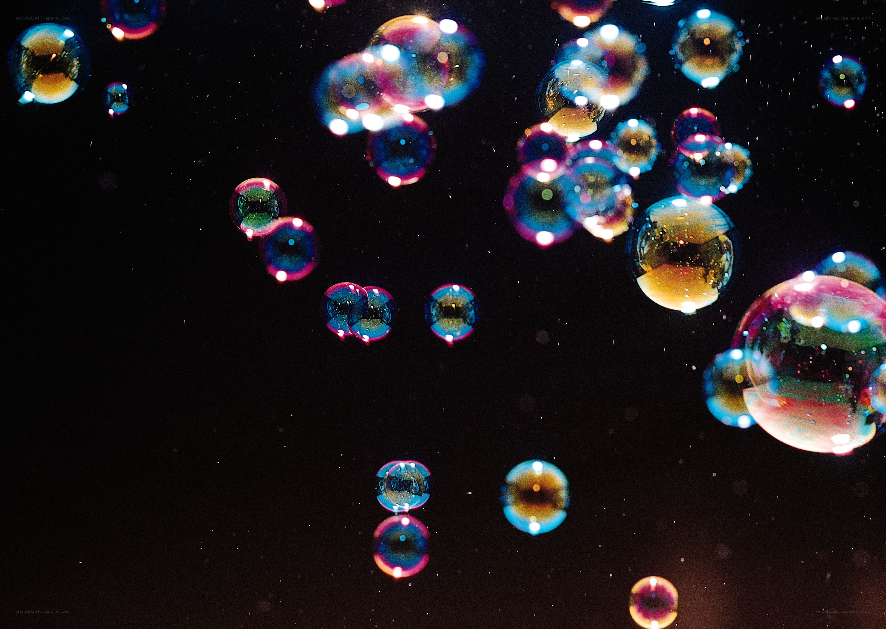 Colorful bubbles floating in darkness