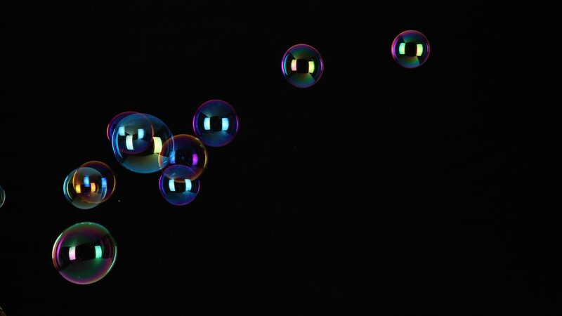 Colorful bubbles floating in darkness