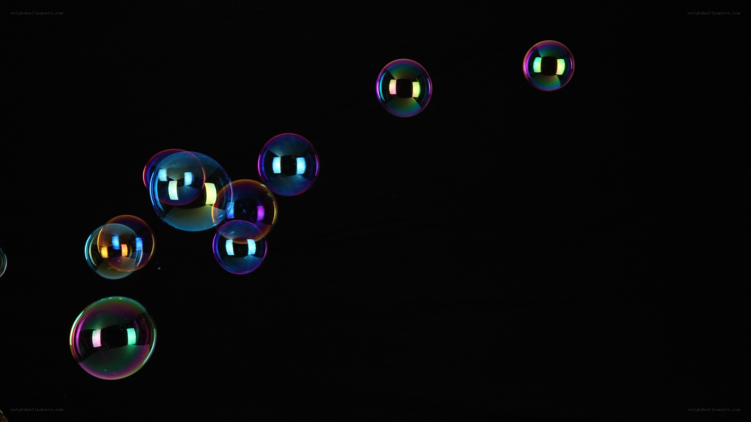 Colorful bubbles floating in darkness
