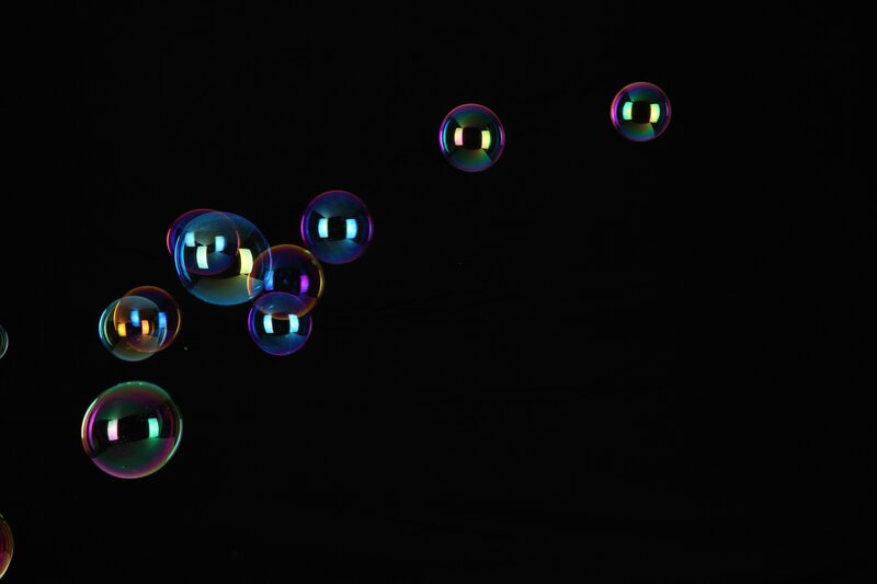 Colorful bubbles floating in darkness