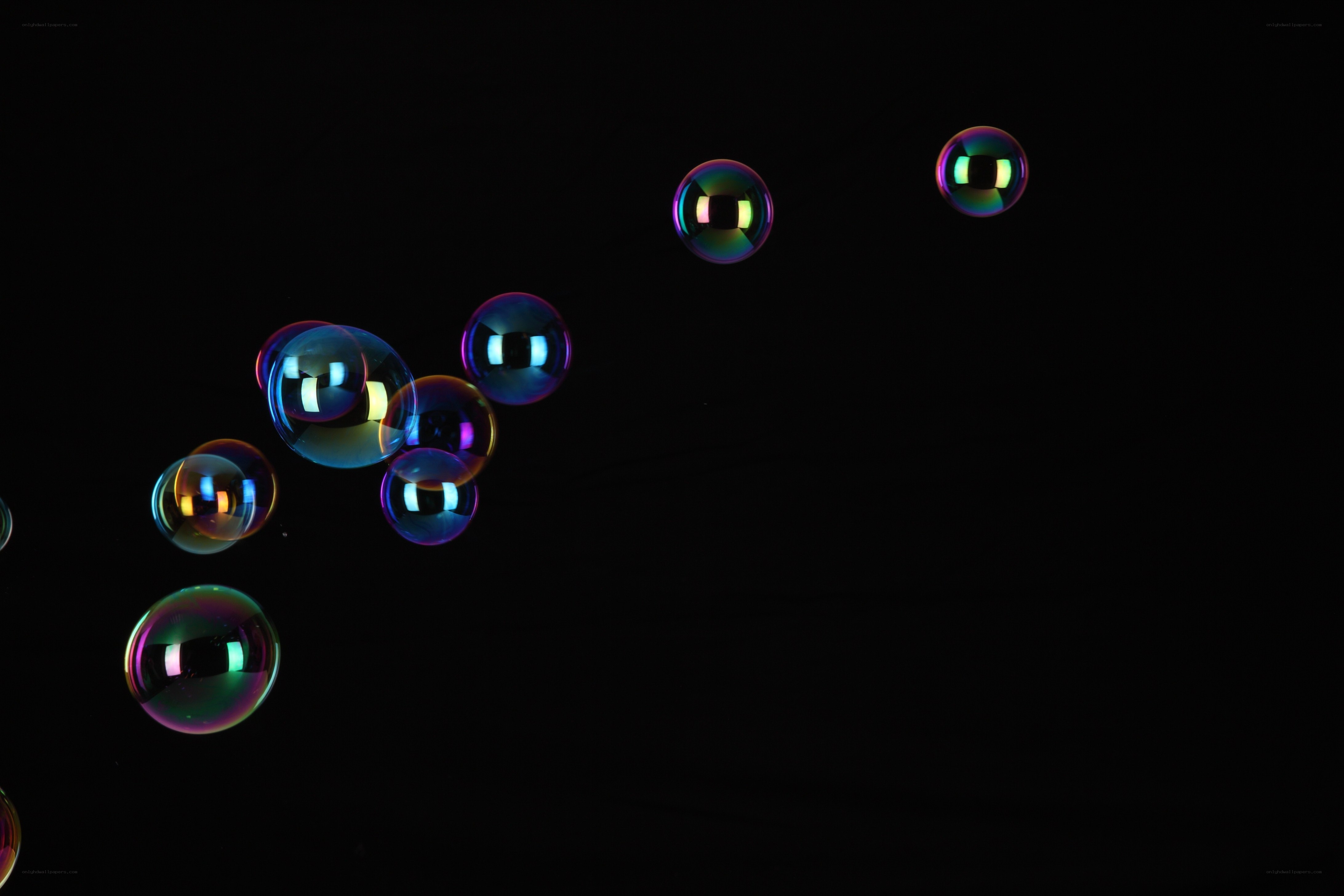 Colorful bubbles floating in darkness