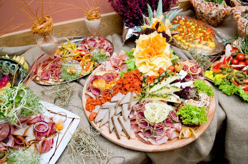 Colorful buffet spread with meats and cheeses