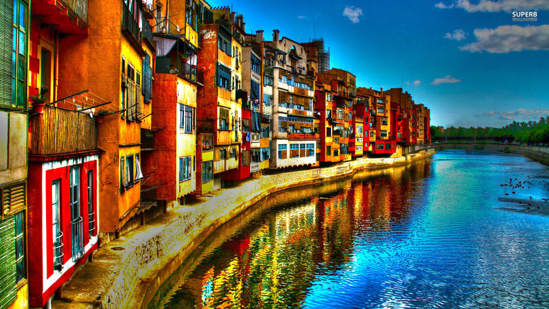 Colorful Buildings Along River — Blue, Vibrant, Afternoon