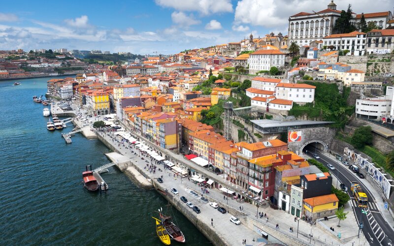 Colorful Buildings Along River — Orange