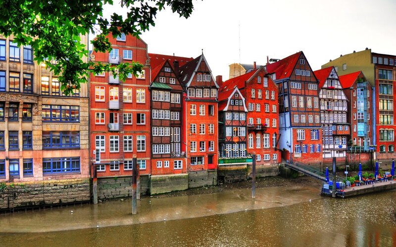 Colorful Buildings Along River — Red