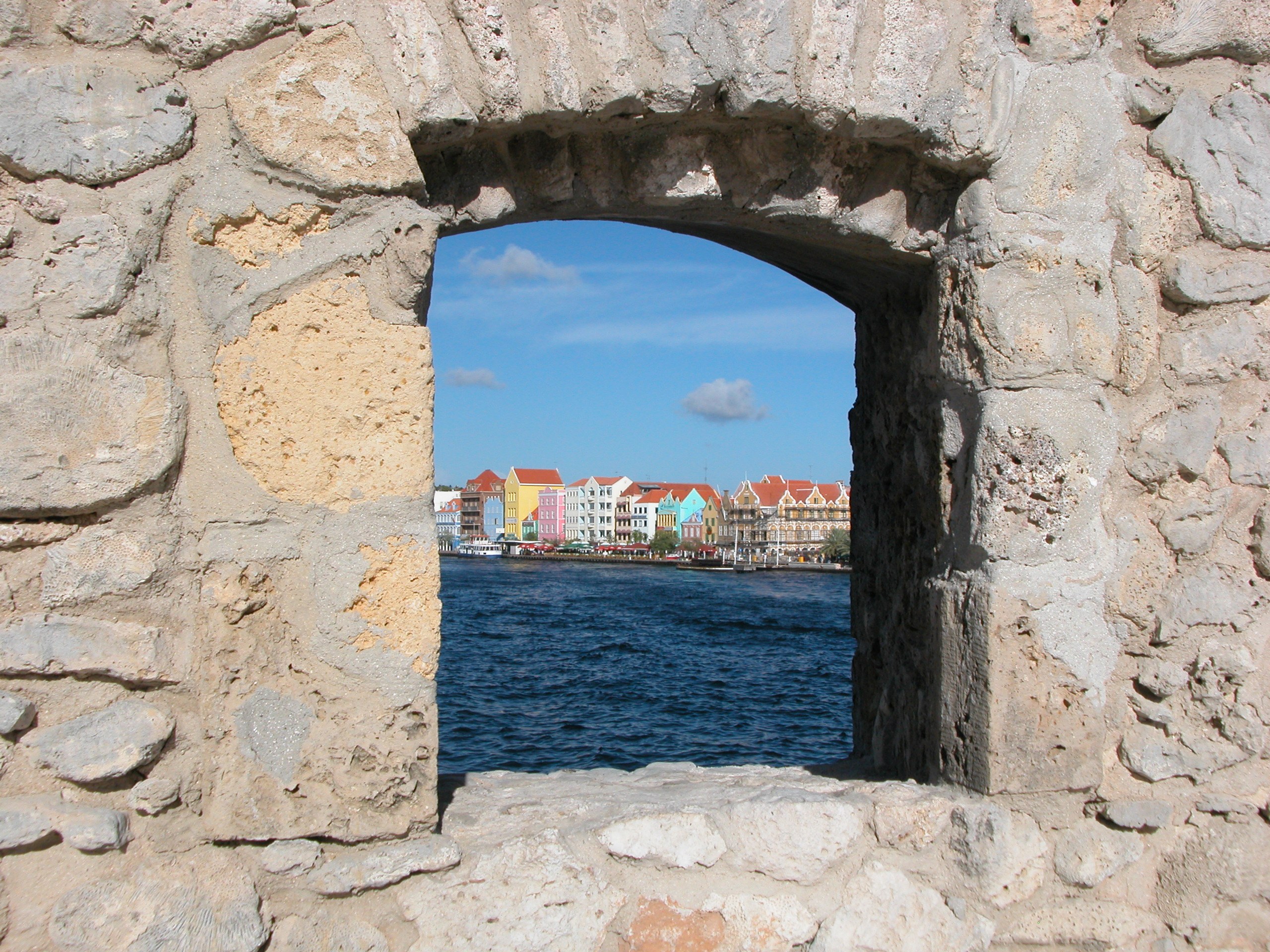 colorful buildings through stone window