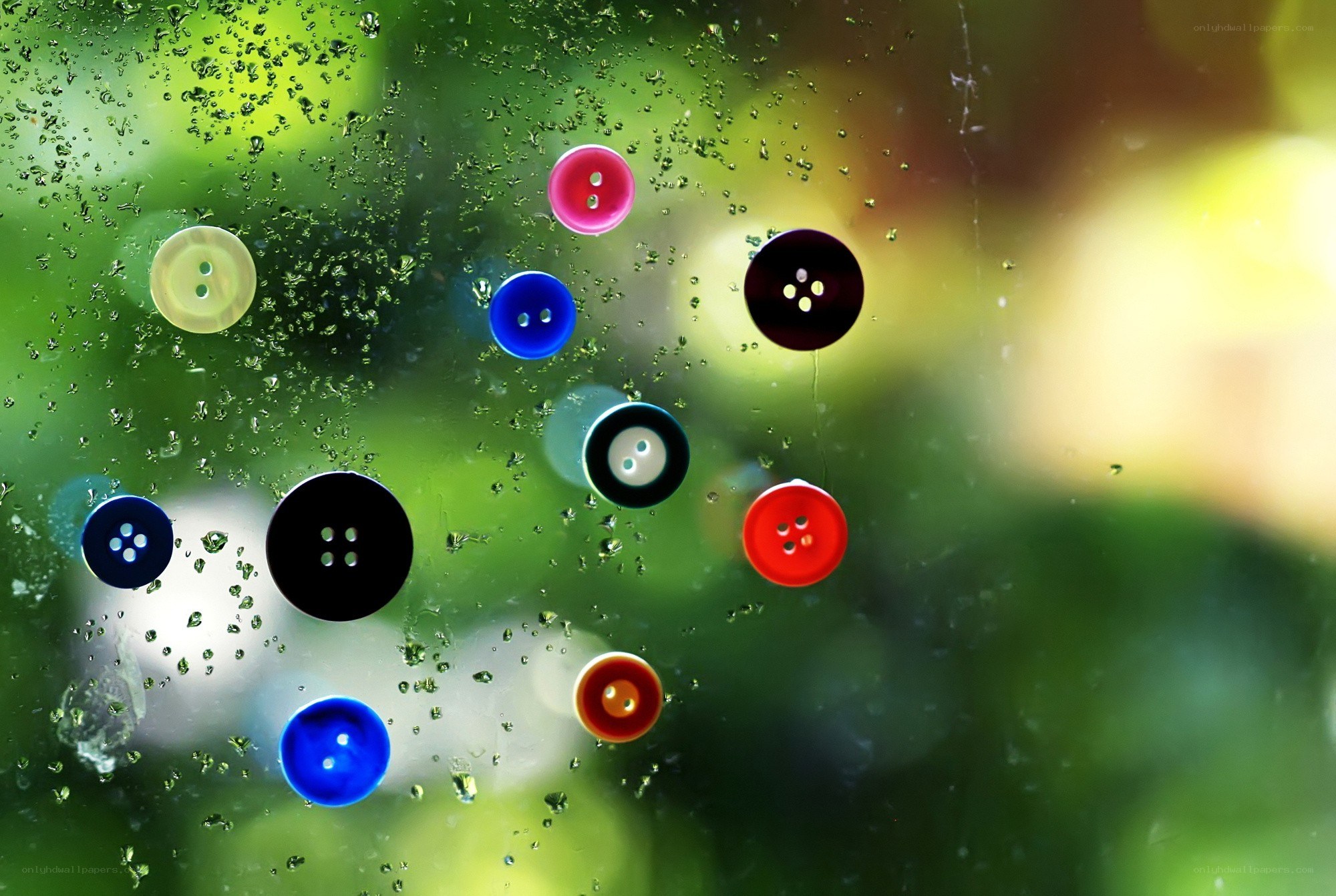 Colorful buttons on a rainy window