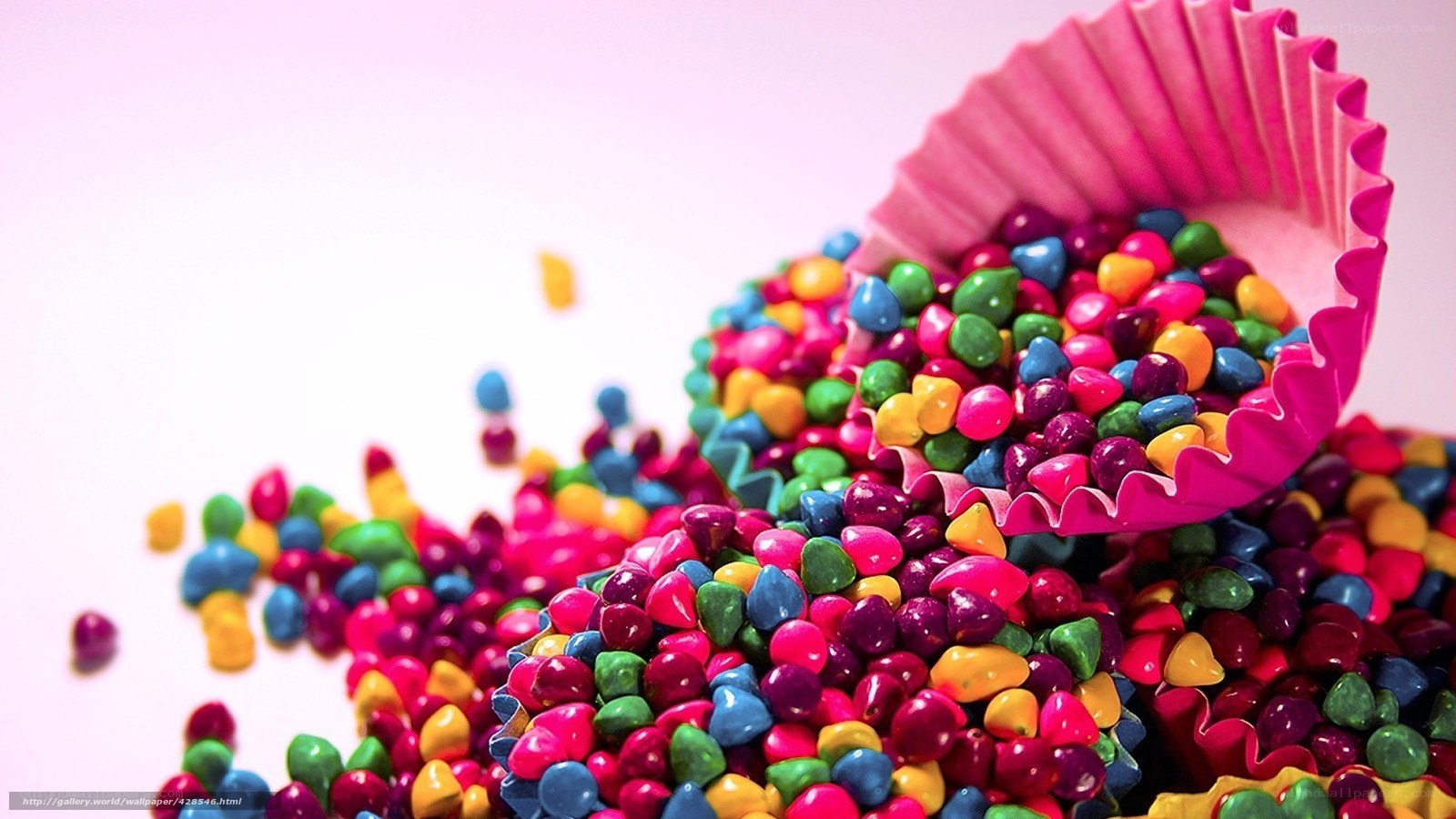 Colorful candies spilling from cupcake liner