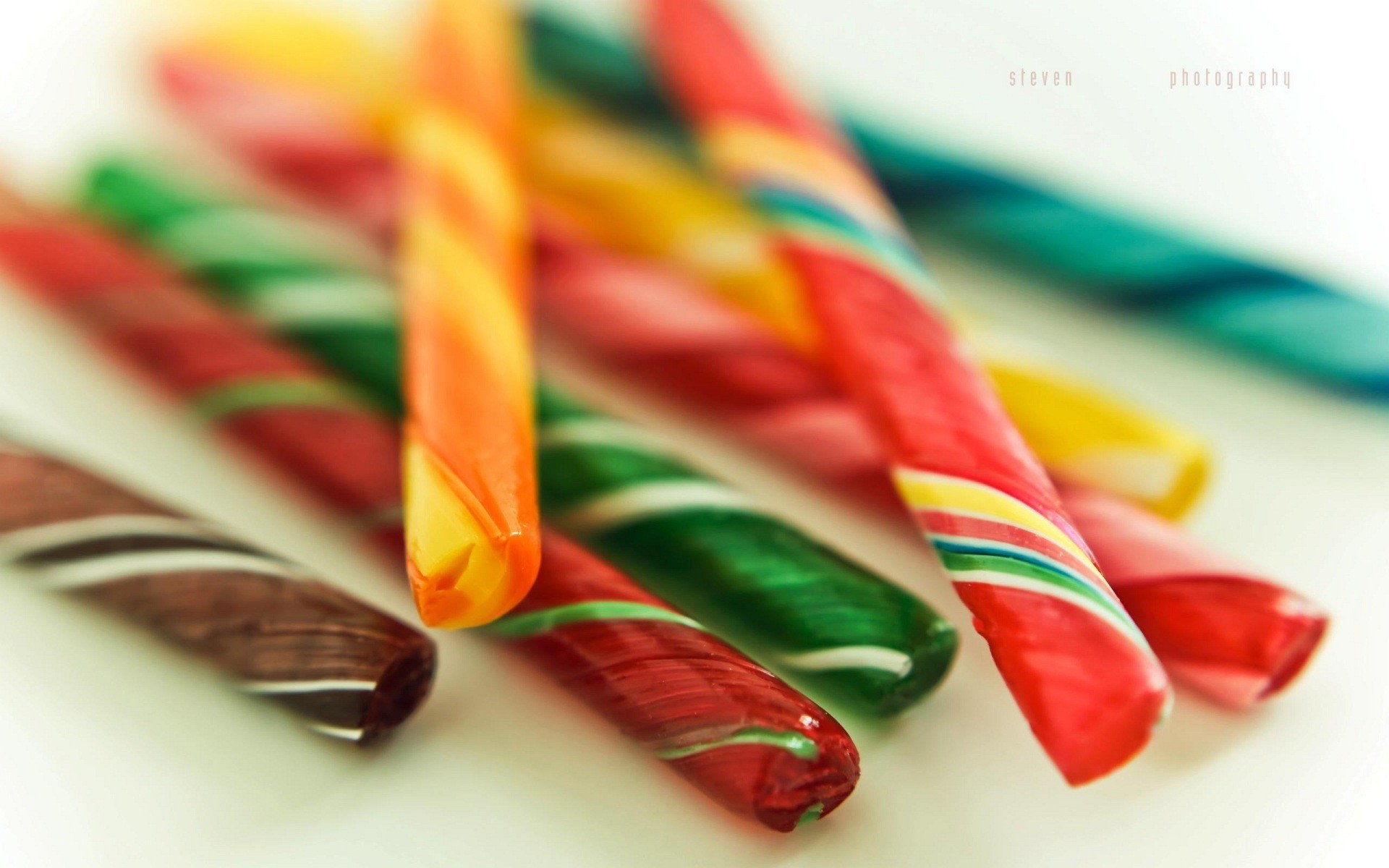 Colorful candy canes on white
