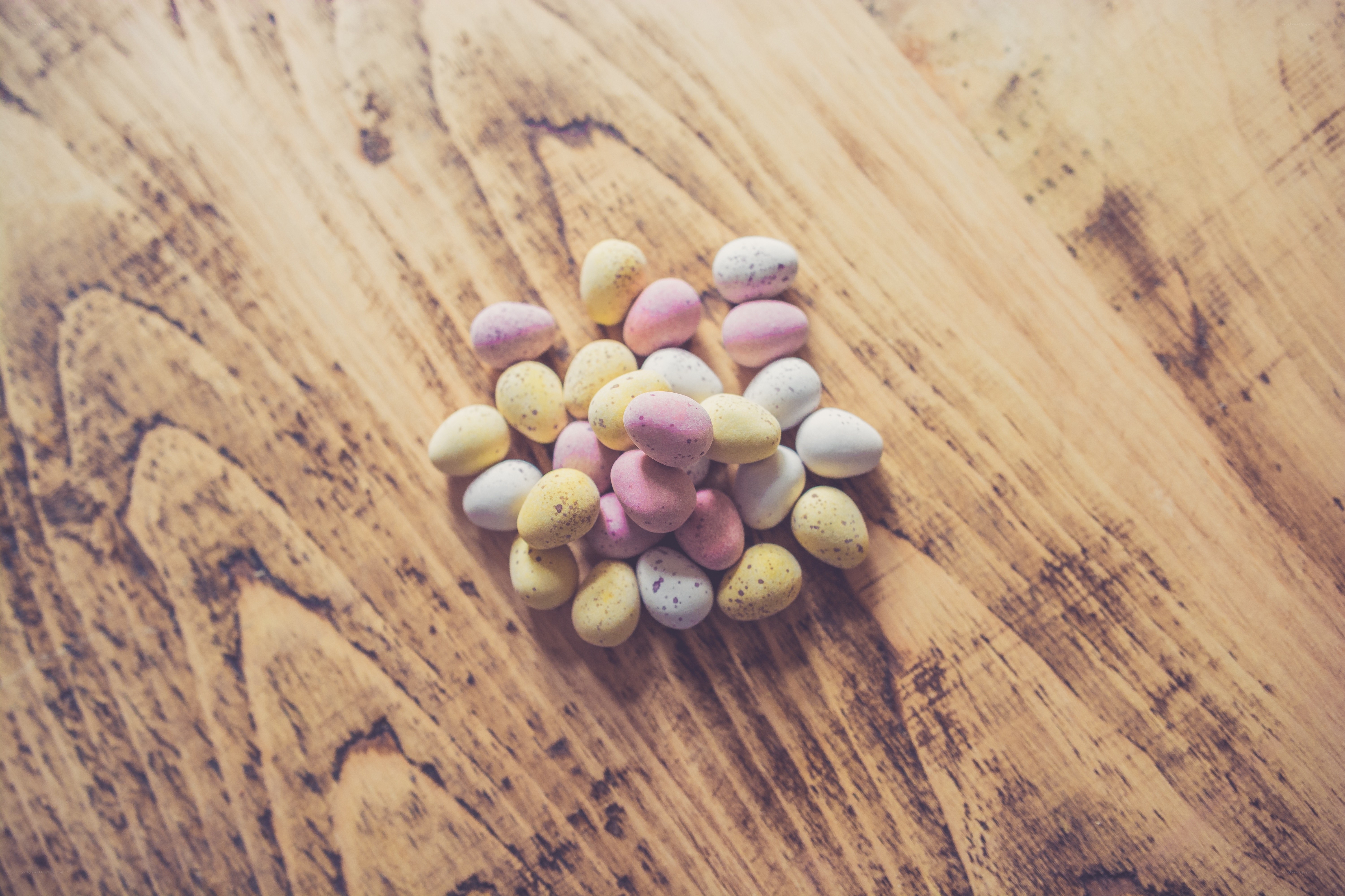 colorful candy eggs on wood