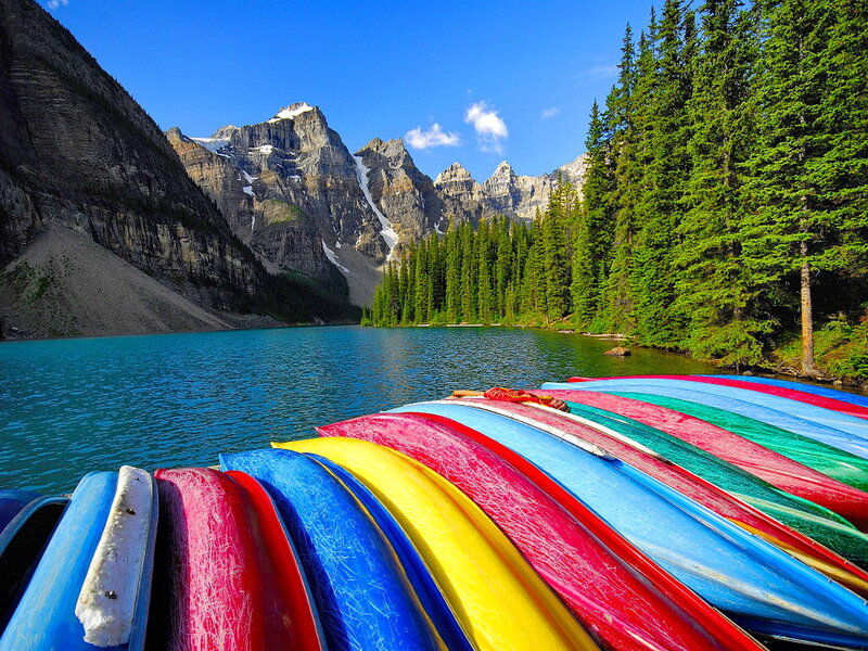 Colorful Canoes on Lake — Blue, Serene