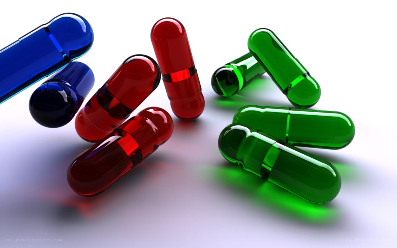 Colorful capsules on white surface