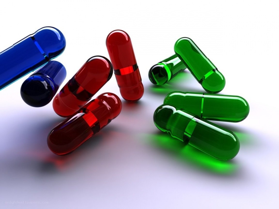 Colorful capsules on white surface