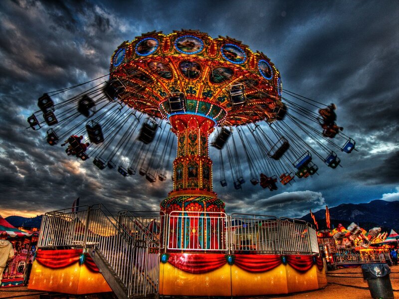 Colorful carousel under stormy sky