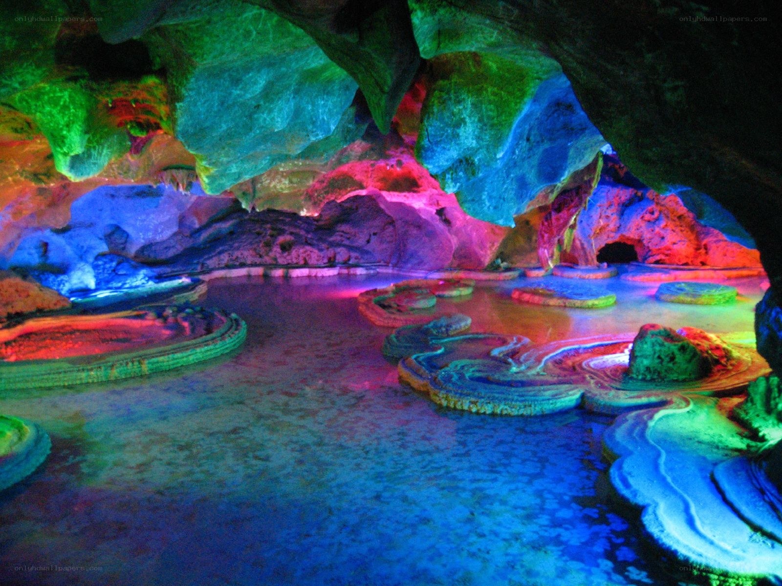 Colorful cave with water pools